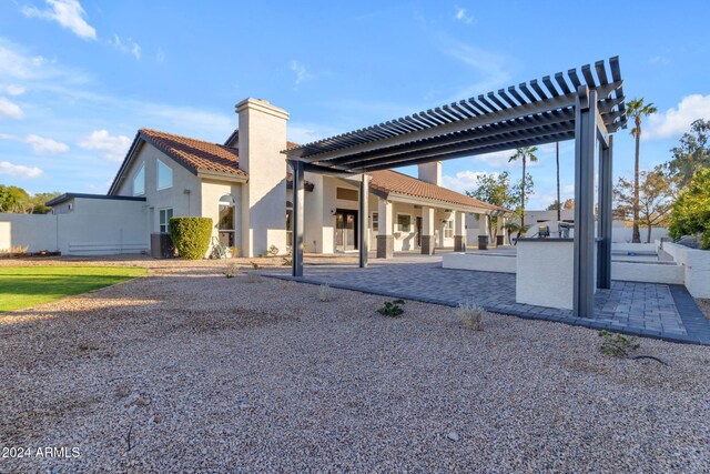 rear view of property featuring a pergola, a patio, and cooling unit