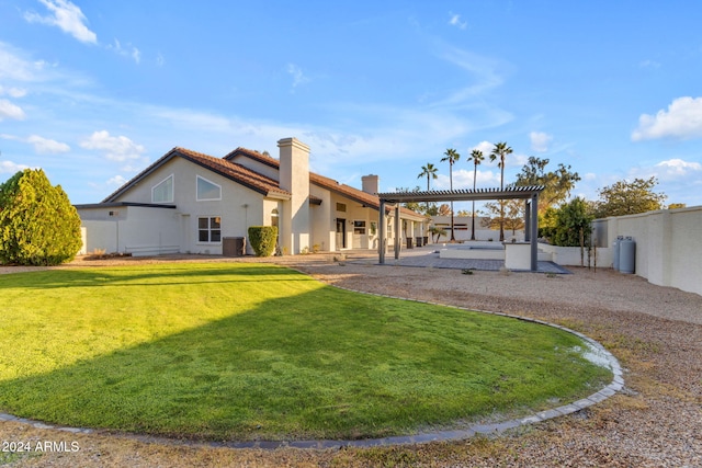 rear view of house with a pergola, a patio, and a yard