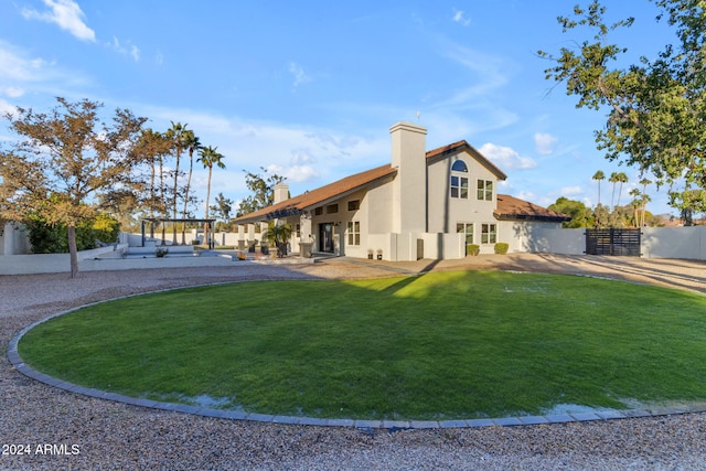 view of front facade with a patio area and a front lawn