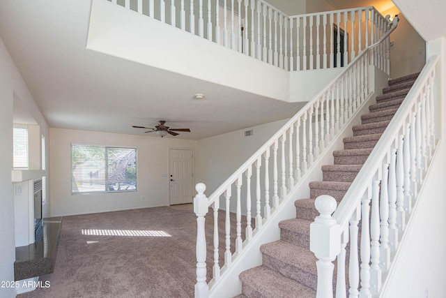 3365 N Sunaire, Mesa, AZ 85215 - stairs with carpet, baseboards, ceiling fan, and a glass covered fireplace