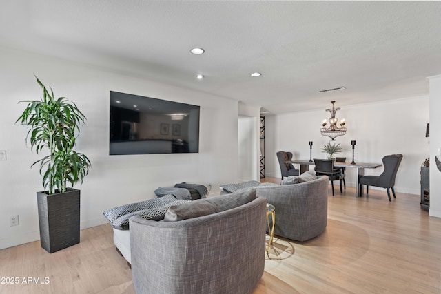 living room featuring recessed lighting, baseboards, a chandelier, visible vents, and light wood-style flooring