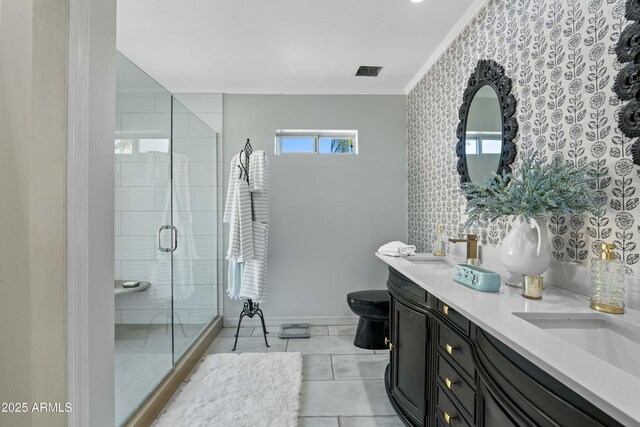 full bathroom featuring visible vents, crown molding, baseboards, double vanity, and a stall shower
