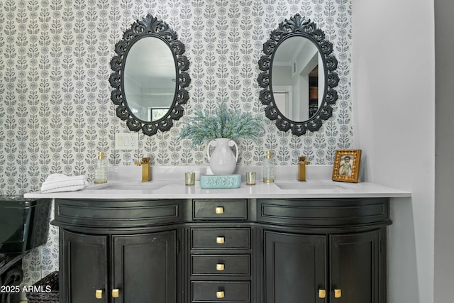 full bath featuring double vanity, a sink, and wallpapered walls