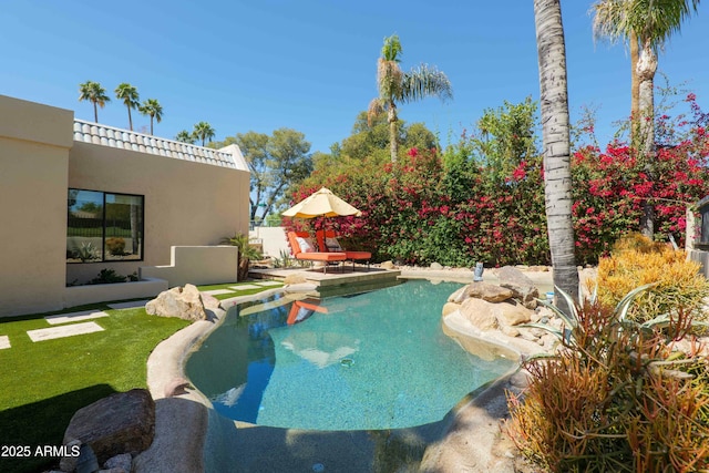 view of swimming pool featuring fence and a patio area