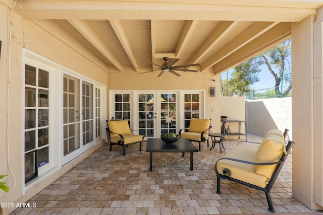 view of patio / terrace with french doors, a ceiling fan, and fence