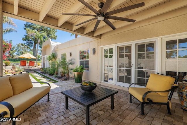 view of patio featuring a ceiling fan, fence, and outdoor lounge area