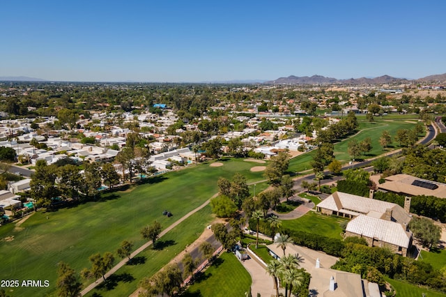 aerial view featuring view of golf course, a residential view, and a mountain view