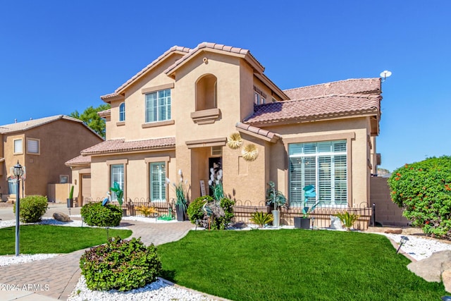 mediterranean / spanish-style home featuring a front yard