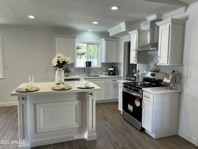 kitchen featuring sink, white cabinetry, tasteful backsplash, electric range, and wall chimney range hood