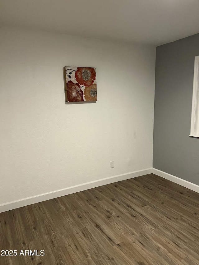 unfurnished room featuring dark hardwood / wood-style flooring