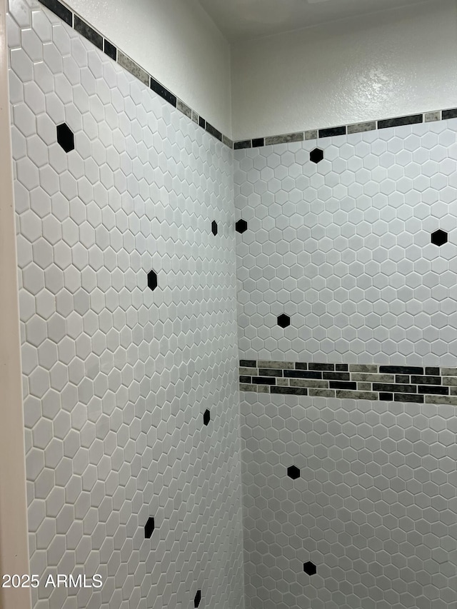 bathroom with tiled shower