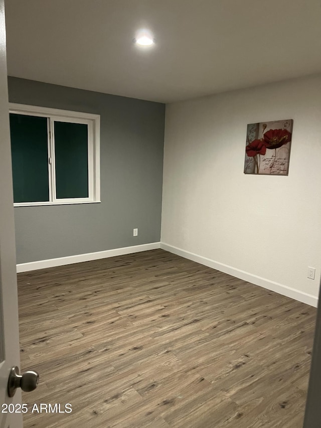 empty room with hardwood / wood-style floors