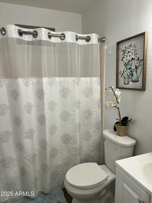 bathroom featuring vanity and toilet