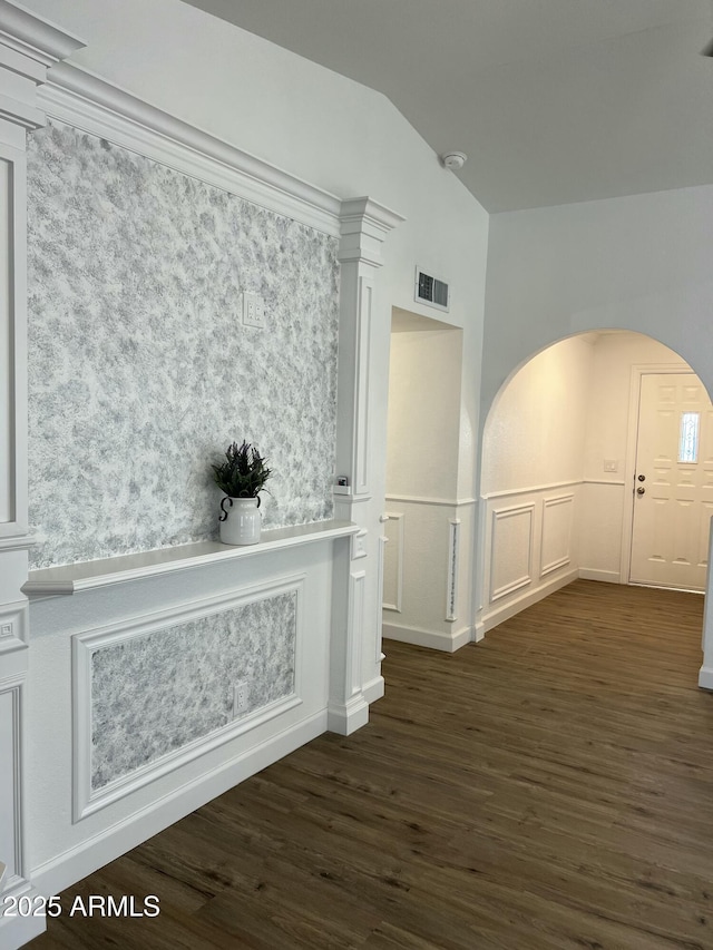 hallway featuring vaulted ceiling and dark hardwood / wood-style floors