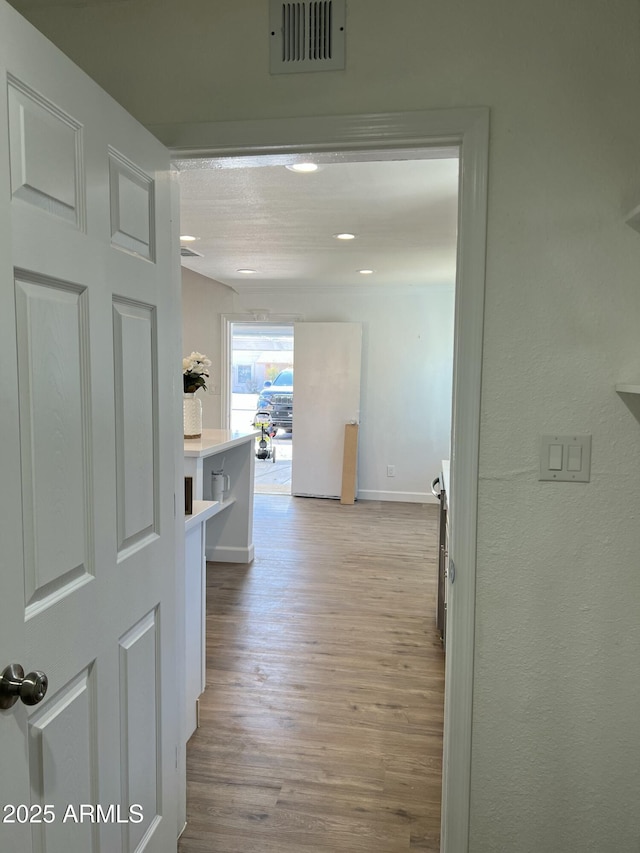 hall with light hardwood / wood-style flooring