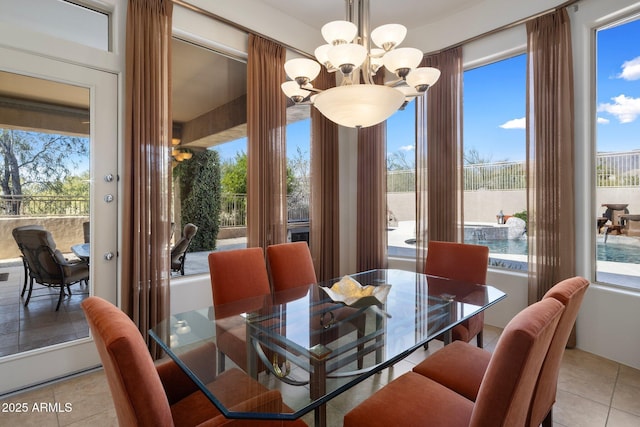 dining room with an inviting chandelier and light tile patterned floors
