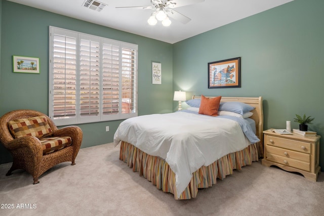 carpeted bedroom with visible vents and ceiling fan
