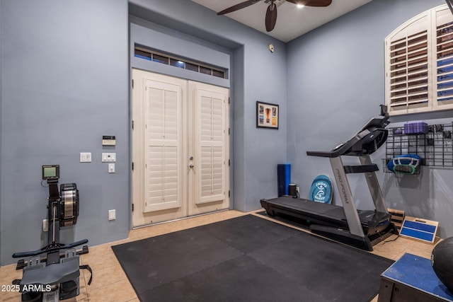 workout area featuring ceiling fan and tile patterned flooring