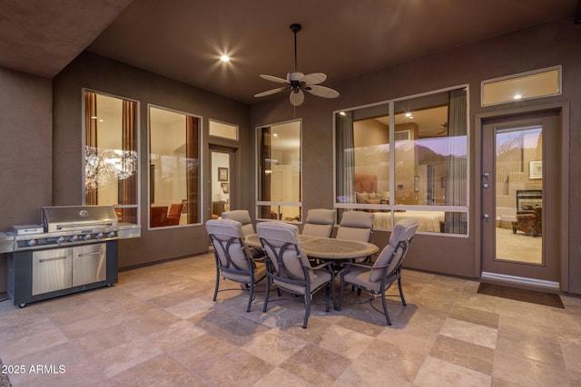 view of patio featuring area for grilling, outdoor dining area, and ceiling fan