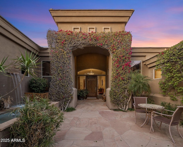 view of patio terrace at dusk