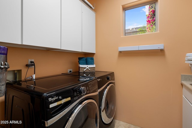clothes washing area with cabinet space and washing machine and clothes dryer