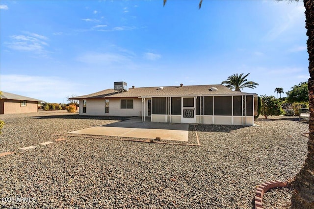 rear view of property with central AC unit, a patio area, and a sunroom