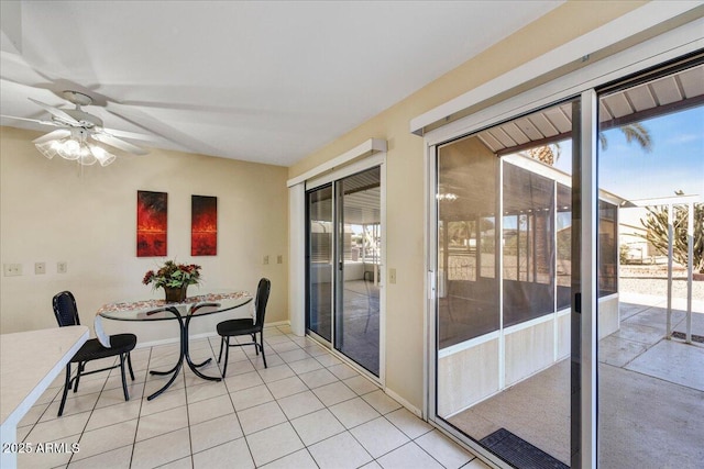 tiled dining space featuring ceiling fan