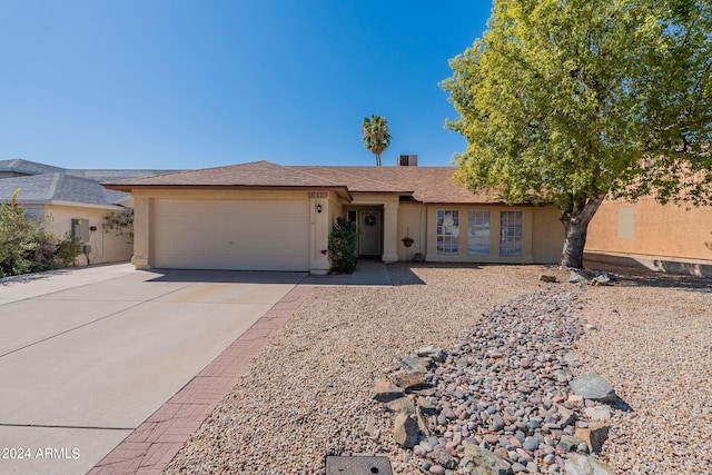 ranch-style house featuring a garage