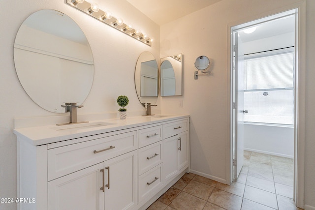16410 S 46th Pl, Phoenix, AZ 85048 - bathroom with double vanity, baseboards, a sink, and tile patterned flooring