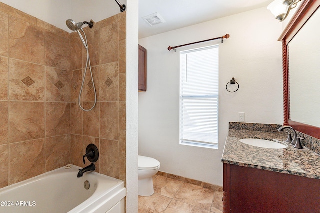 full bathroom featuring vanity, tile patterned flooring, toilet, and tiled shower / bath combo