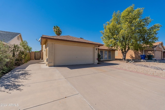 16410 S 46th Pl, Phoenix, AZ 85048 - single story home with fence, an attached garage, concrete driveway, and french doors