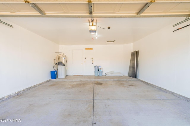 garage with water heater and a garage door opener