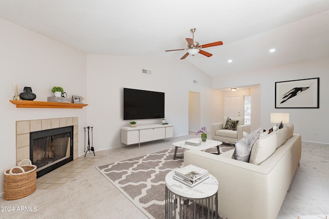 living room featuring ceiling fan, light colored carpet, a fireplace, and vaulted ceiling