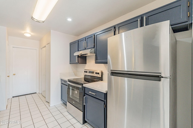 kitchen featuring blue cabinets, stainless steel appliances, and light tile patterned floors