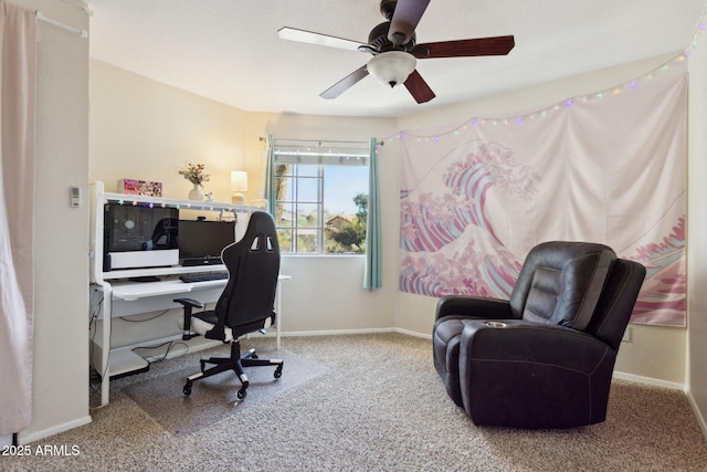 home office featuring carpet floors, ceiling fan, and baseboards