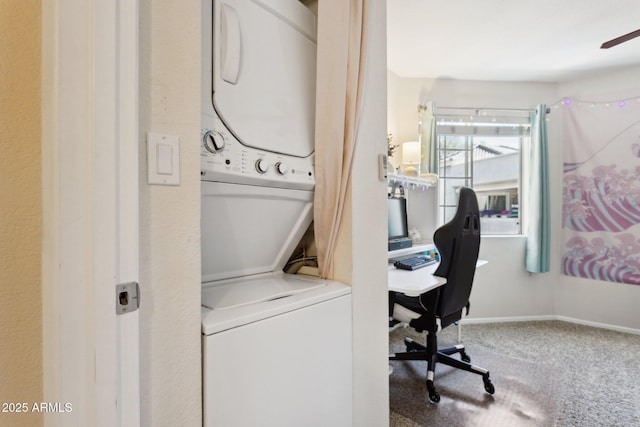 laundry room with stacked washer and dryer, carpet flooring, laundry area, and baseboards