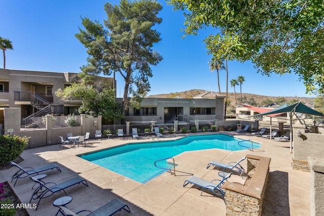 community pool featuring a patio and fence