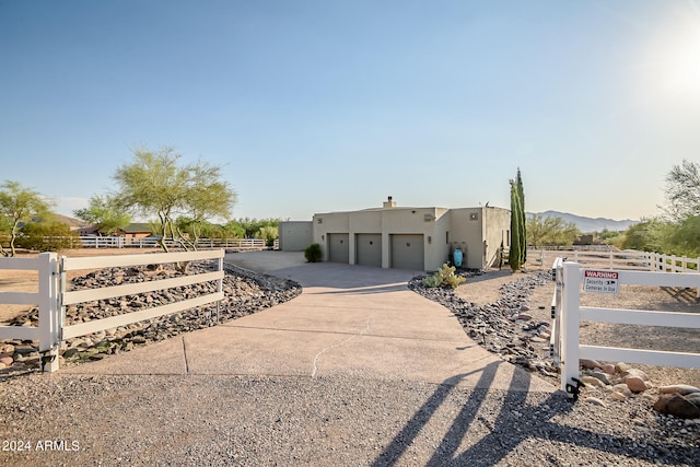 pueblo-style home featuring a garage