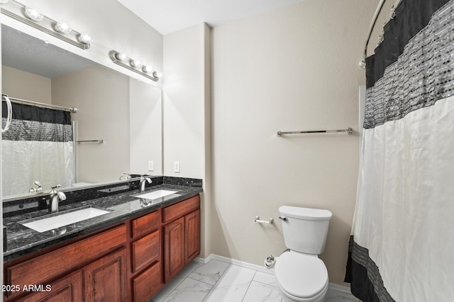 full bath with marble finish floor, double vanity, a sink, and toilet