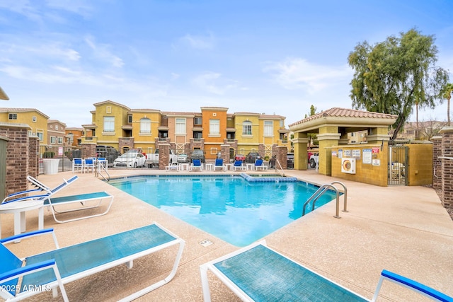 pool featuring fence and a patio