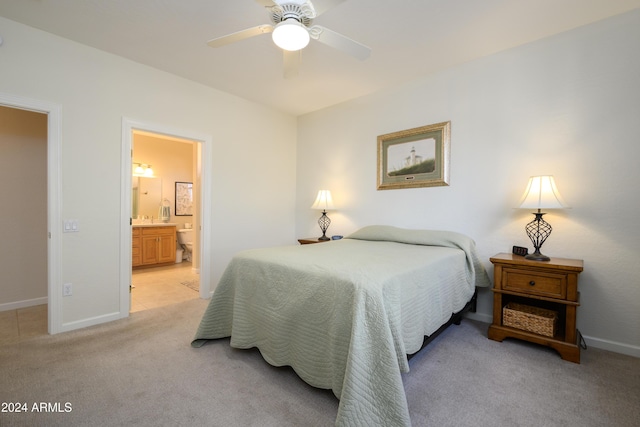 bedroom featuring ensuite bath, ceiling fan, and light carpet