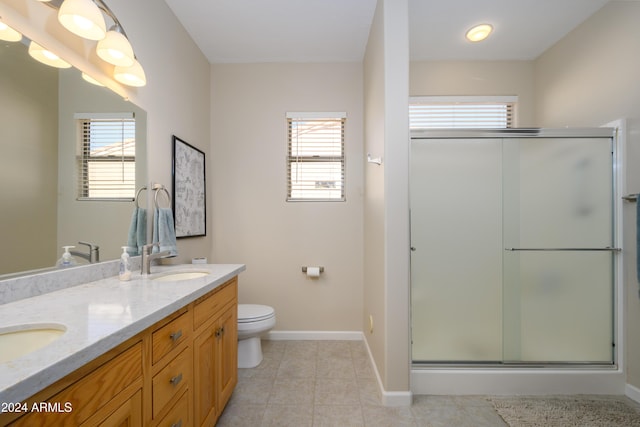 bathroom featuring vanity, tile patterned floors, an enclosed shower, and a healthy amount of sunlight