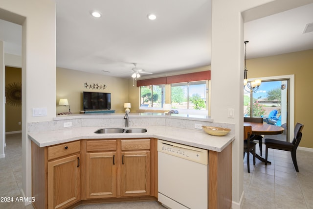 kitchen with ceiling fan with notable chandelier, white dishwasher, sink, pendant lighting, and light tile patterned floors