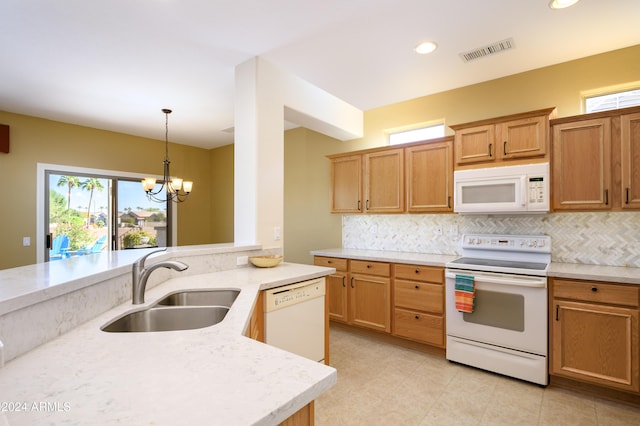 kitchen with decorative backsplash, white appliances, sink, pendant lighting, and an inviting chandelier