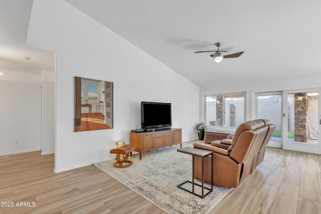 living area featuring light wood finished floors, high vaulted ceiling, and a ceiling fan