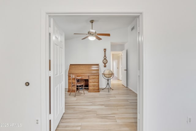 interior space with light wood-style floors, visible vents, and baseboards