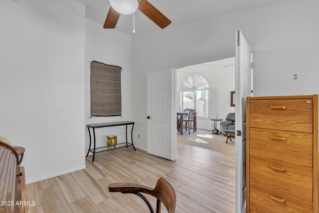 sitting room featuring a ceiling fan, wood finish floors, and baseboards