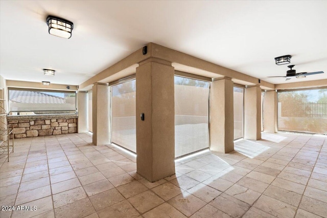 unfurnished room with a healthy amount of sunlight and ceiling fan