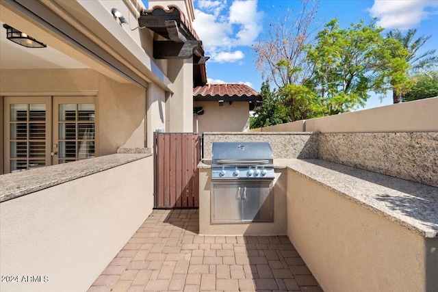 view of patio / terrace featuring area for grilling and a grill