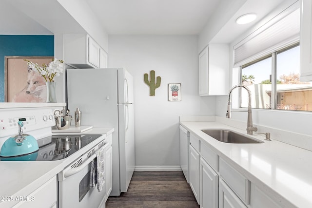 kitchen with dark wood-style floors, white electric stove, light countertops, white cabinetry, and a sink